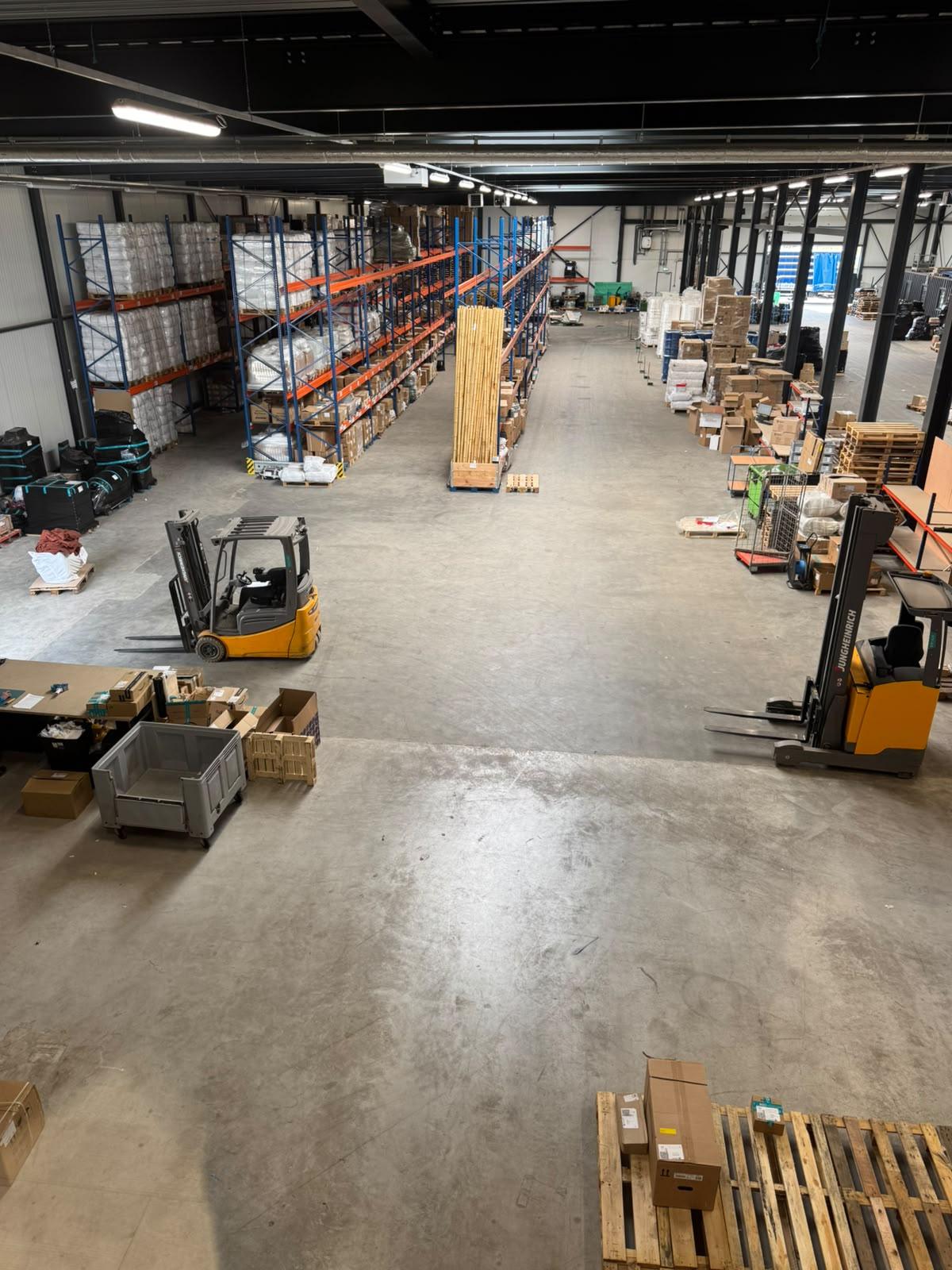 Overview of the MIQ warehouse floor with pallet racking and reach trucks
